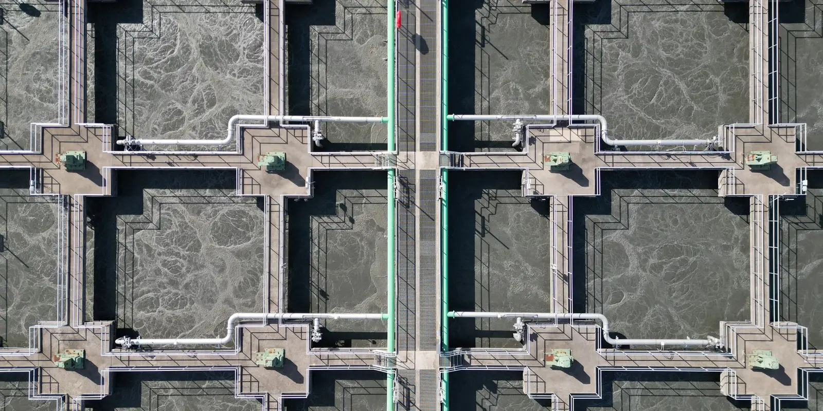 Aerial view of treatment basins, walkways and pipework at a water treatment plant