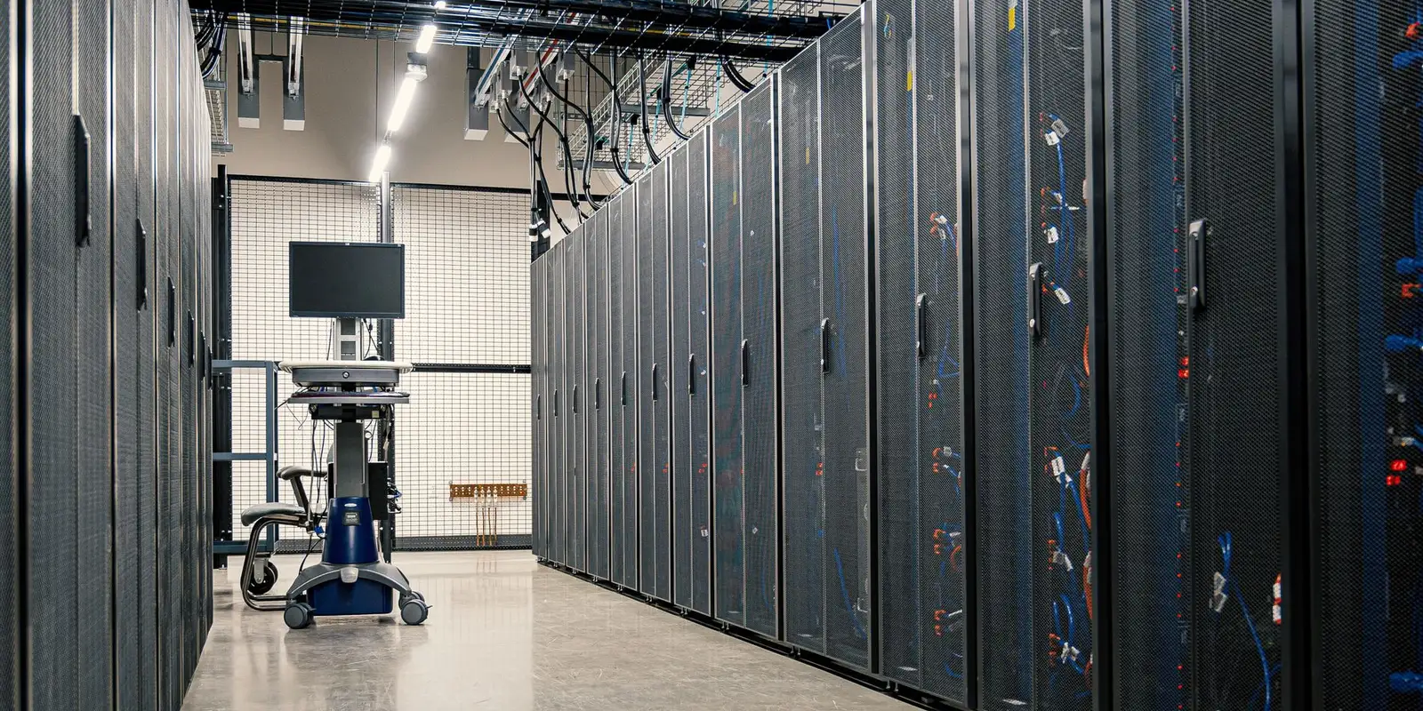 Rows of server racks in a modern data centre aisle