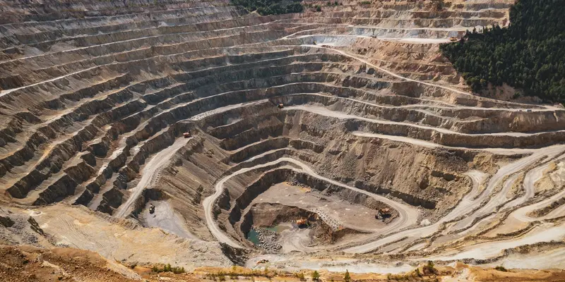 Aerial view of terraced benches in an open pit mine