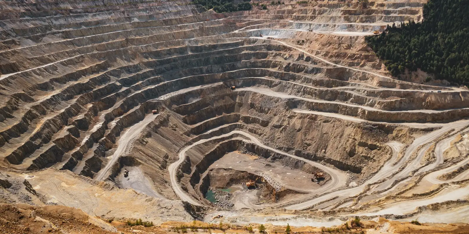 Aerial view of terraced benches in an open pit mine