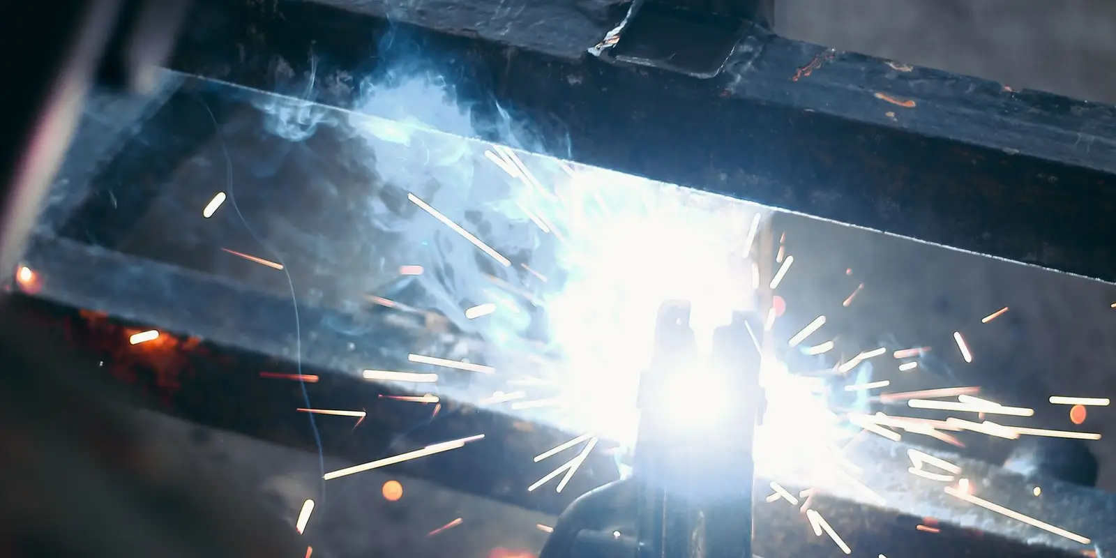 Welding a steel frame in a fabrication workshop