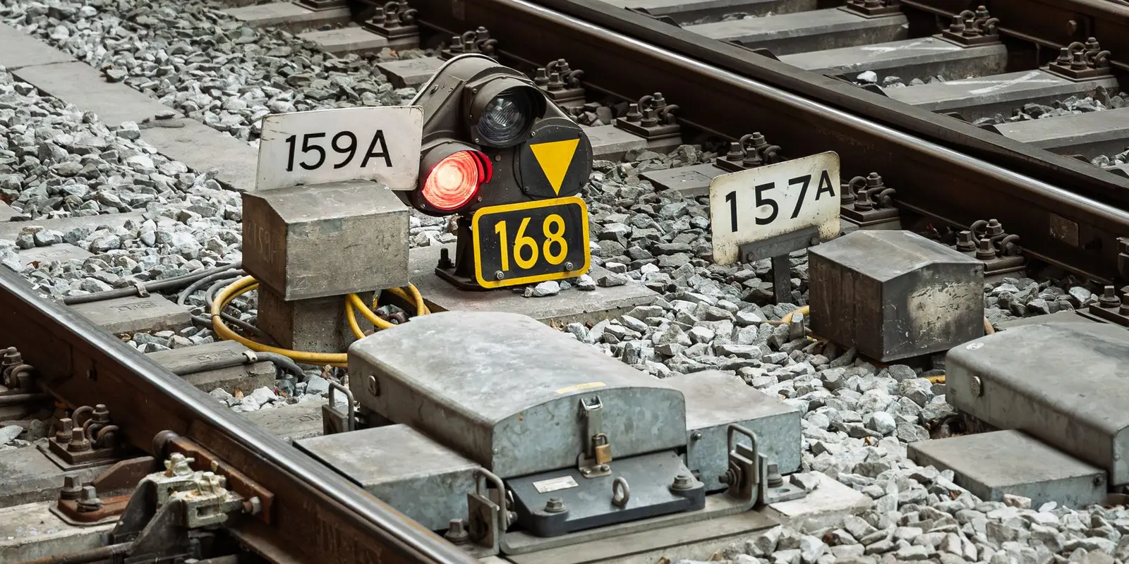 Track signal, points machines and numbered location markers on a rail corridor